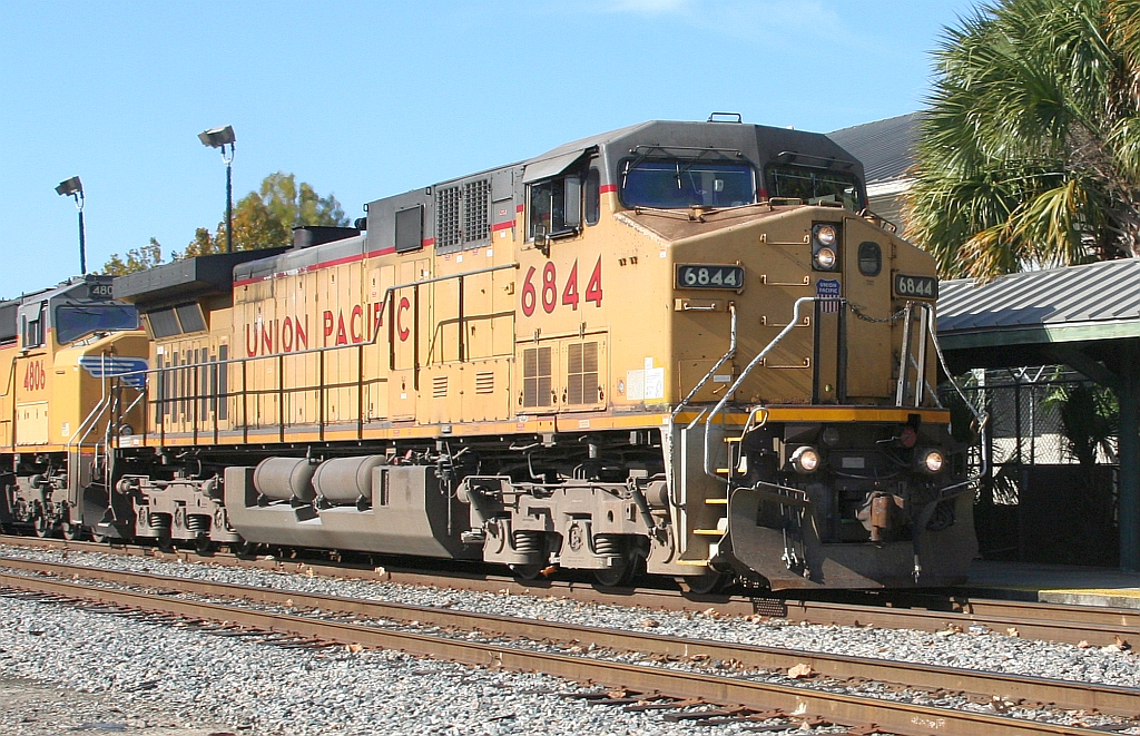 UP 6844 leading Q606 by the depot